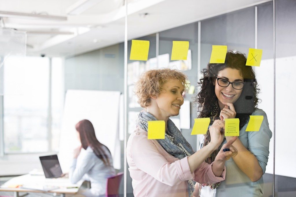 Employees looking at sticky notes